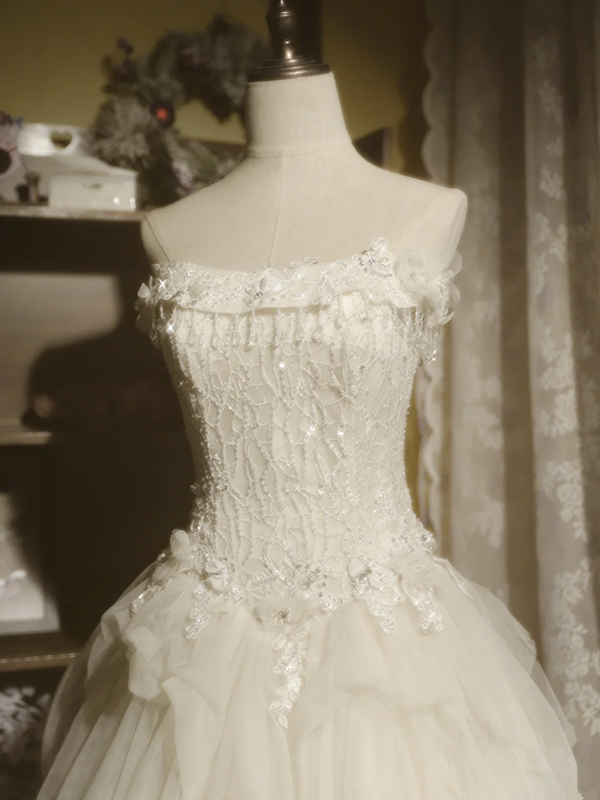 White strapless ball gown with a cinched waist and a voluminous tiered cake skirt; bridal gown R7289