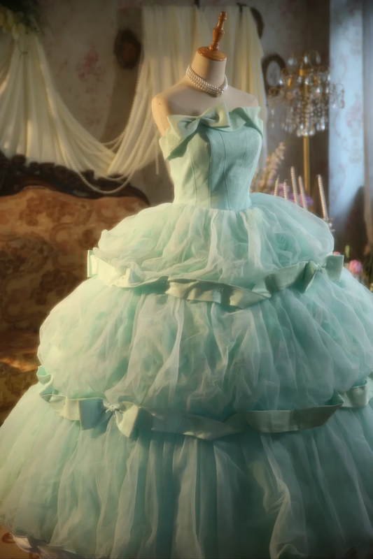 Light green strapless ball gown with a cinched waist and a voluminous puffy skirt; bridal gown R7283