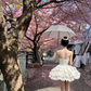 Light apricot strapless fitted waist short ball gown with a flared tiered skirt R8027