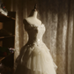 White strapless ball gown with a cinched waist and a voluminous tiered cake skirt; bridal gown R7289