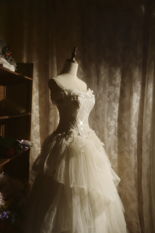 White strapless ball gown with a cinched waist and a voluminous tiered cake skirt; bridal gown R7289