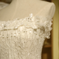 White strapless ball gown with a cinched waist and a voluminous tiered cake skirt; bridal gown R7289