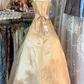 A gold, backless, fitted long dress with a multi-layered, voluminous skirt; a ball gown R6298