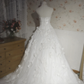 White strapless ball gown with a cinched waist and a voluminous puffy skirt; bridal gown R7291
