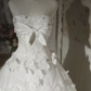 White strapless ball gown with a cinched waist and a voluminous puffy skirt; bridal gown R7291