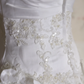 White strapless ball gown with a cinched waist and a voluminous puffy skirt; bridal gown R7291