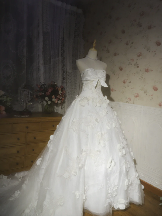 White strapless ball gown with a cinched waist and a voluminous puffy skirt; bridal gown R7291