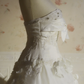 White strapless ball gown with a cinched waist and a voluminous puffy skirt; bridal gown R7291