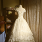 White off-the-shoulder floor-length ball gown with a cinched waist, slim fit and voluminous puffy skirt; bridal gown R7293