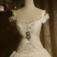 White off-the-shoulder floor-length ball gown with a cinched waist, slim fit and voluminous puffy skirt; bridal gown R7293