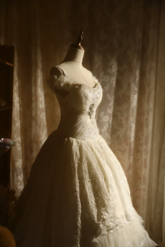 White off-the-shoulder floor-length ball gown with a cinched waist, slim fit and voluminous puffy skirt; bridal gown R7293