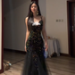 Sexy ball gown with black halter neck, fitted waist, and sequined fishtail skirt. R8065