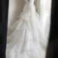 White strapless, fitted, long ball gown with a tiered skirt; bridal gown R6822