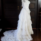 White lace square-neck long-sleeve ball gown with a cinched waist, vintage style and tiered cake skirt; bridal gown R7295