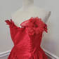 Red strapless ball gown with a cinched waist and an asymmetrical skirt; bridal gown R7297