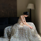 Sheer white base with appliqué, strapless, waist‑cinched, slim‑fit, long ball gown with a voluminous ruffled skirt R8015