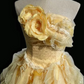 Light orange strapless ball gown with a cinched waist and a voluminous tiered cake skirt; bridal gown R7302