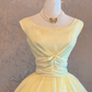 Light yellow sleeveless ball gown with a cinched waist and a voluminous puffy skirt; bridal gown R7303