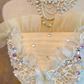 Light yellow strapless ball gown with a cinched waist and a voluminous puffy skirt; bridal gown R7308