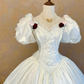 White square-neck ball gown with puff sleeves, vintage style, a cinched waist, slim fit and a voluminous puffy skirt; bridal gown R7309