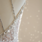 A sexy ball gown with a silver rhinestone halter neck and fitted waist, featuring a foundation and a bridal gown. R8550