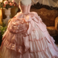 Pink strapless ball gown with a cinched waist and a voluminous tiered cake skirt; bridal gown R7282