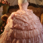 Pink strapless ball gown with a cinched waist and a voluminous tiered cake skirt; bridal gown R7282