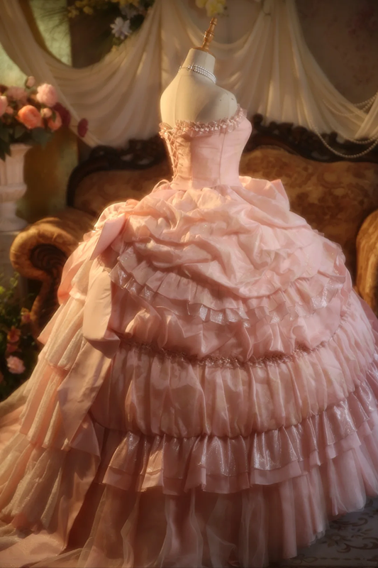 Pink strapless ball gown with a cinched waist and a voluminous tiered cake skirt; bridal gown R7282