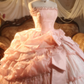Pink strapless ball gown with a cinched waist and a voluminous tiered cake skirt; bridal gown R7282