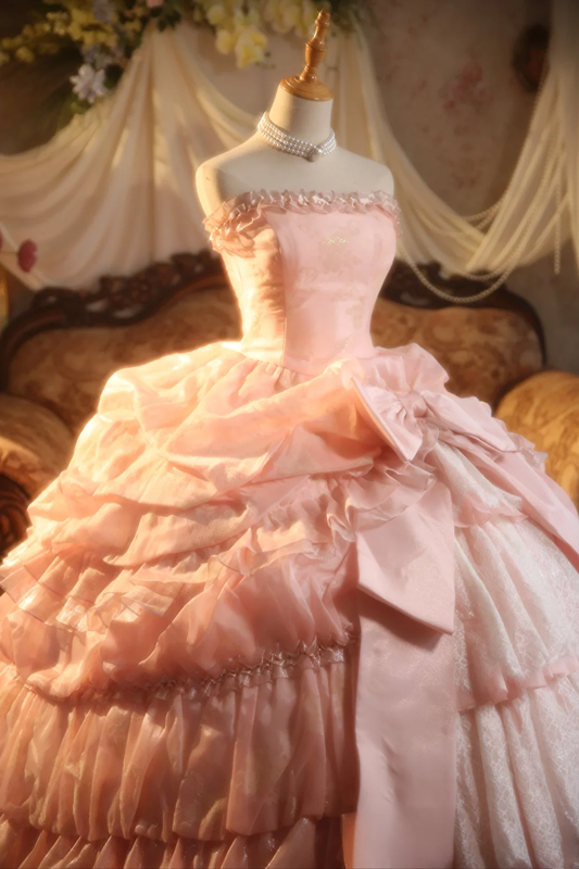 Pink strapless ball gown with a cinched waist and a voluminous tiered cake skirt; bridal gown R7282