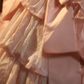 Pink strapless ball gown with a cinched waist and a voluminous tiered cake skirt; bridal gown R7282