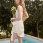 White Ruched Cami Mini Dress with Eyelet Lace Trim, Bow Tie Detail and Asymmetric Hem R9259