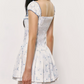 White Floral Corset Mini Dress with Ruffled Trim Neckline, Puff Cap Sleeves, Pleated Skirt and Smocked Back R9252