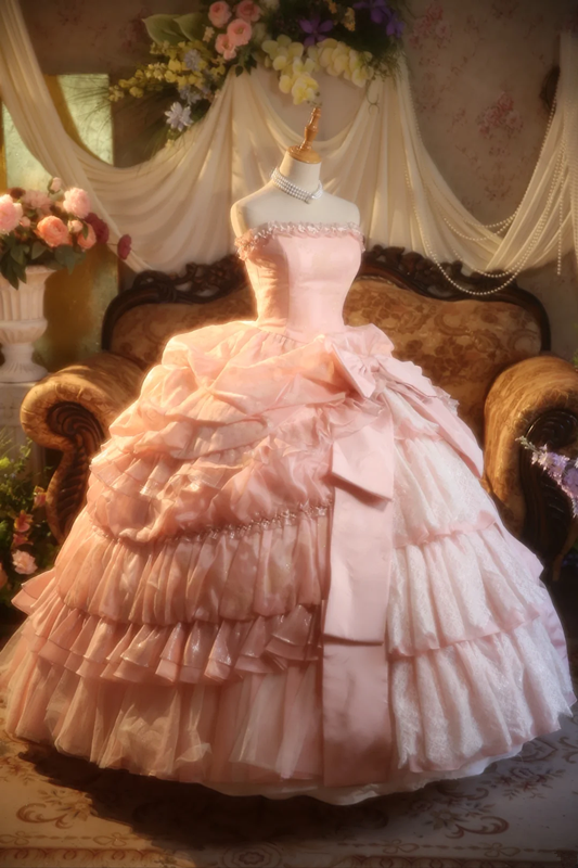 Pink strapless ball gown with a cinched waist and a voluminous tiered cake skirt; bridal gown R7282