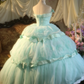 Light green strapless ball gown with a cinched waist and a voluminous puffy skirt; bridal gown R7283