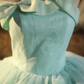 Light green strapless ball gown with a cinched waist and a voluminous puffy skirt; bridal gown R7283