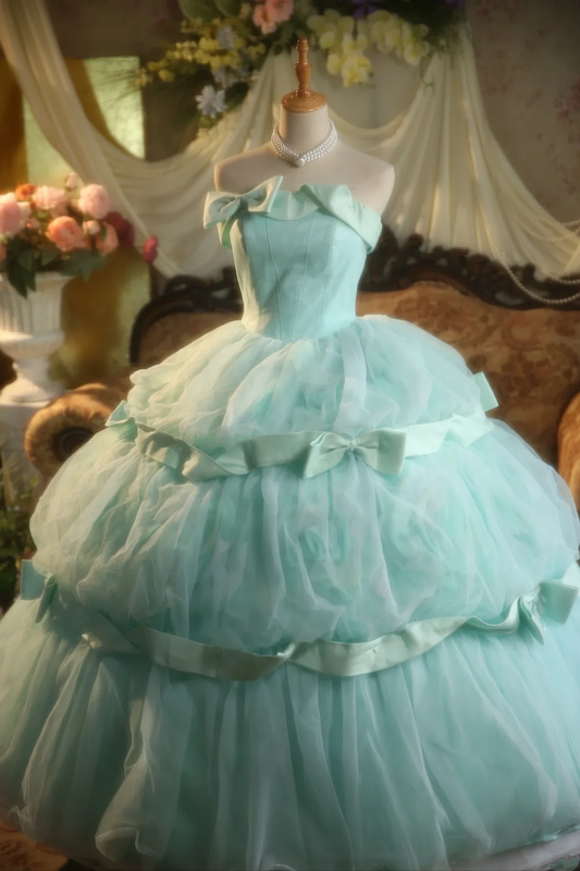 Light green strapless ball gown with a cinched waist and a voluminous puffy skirt; bridal gown R7283